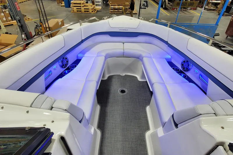 Slide: The Image of Luxurious 2020 Formula 310 Bowrider boat interior with blue LED lighting and spacious seating. - 36