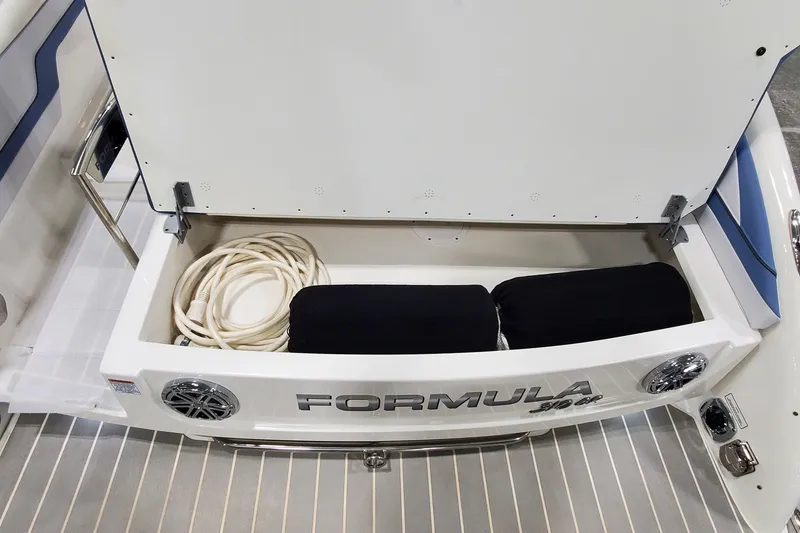 Slide: The Image of 2020 Formula 310 Bowrider storage compartment with coiled rope and cushions. - 8