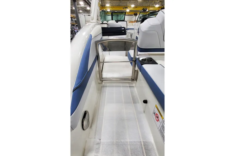 Slide: The Image of 2020 Formula 310 Bowrider interior with blue and white seating, stainless steel gate. - 9