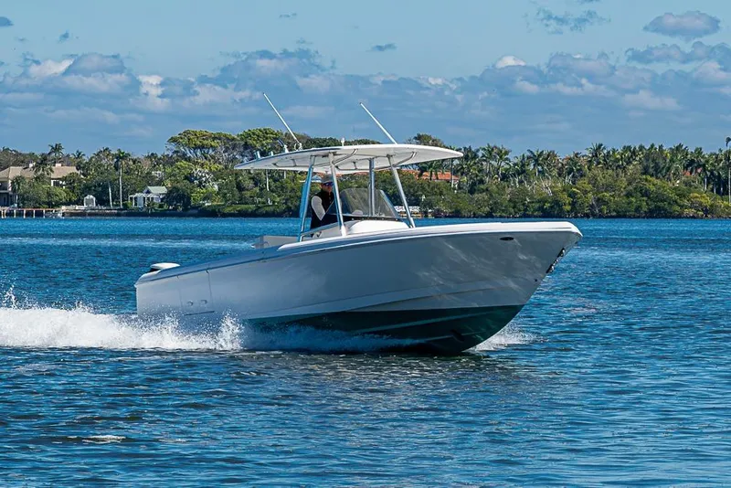 The Image of 2005 Intrepid 300 Center Console boat cruising on a sunny day. - 1