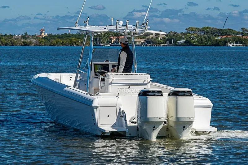 Slide: The Image of 2005 Intrepid 300 Center Console boat cruising on a sunny day. - 11