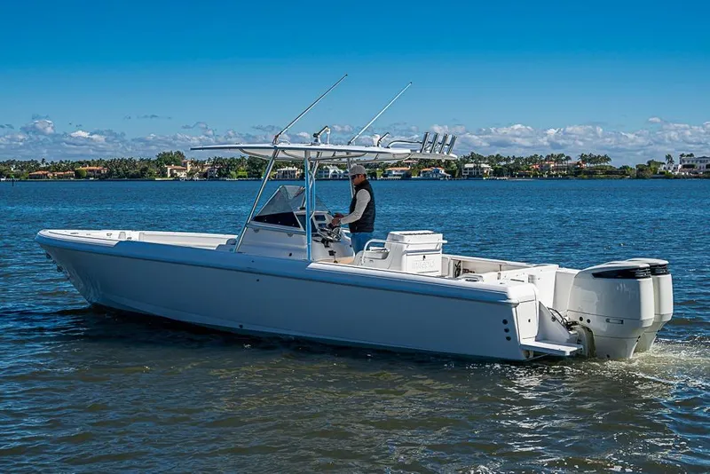 Slide: The Image of 2005 Intrepid 300 Center Console boat cruising on a sunny day. - 12