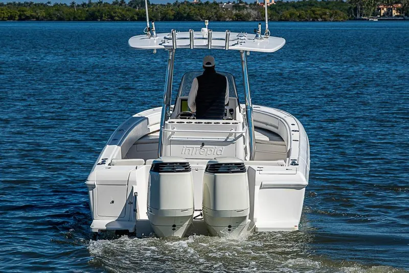 Slide: The Image of 2005 Intrepid 300 Center Console boat cruising on calm waters. - 14