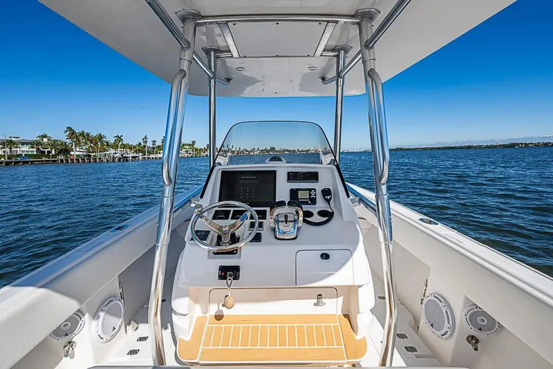 Slide: The Image of 2005 Intrepid 300 Center Console boat on calm water, featuring a sleek helm design. - 15