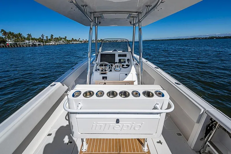 Slide: The Image of 2005 Intrepid 300 Center Console boat on calm water, featuring a sleek helm design. - 16