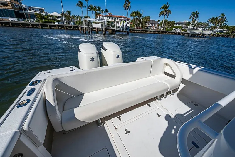 Slide: The Image of 2005 Intrepid 300 Center Console boat with seating, docked near waterfront homes. - 19