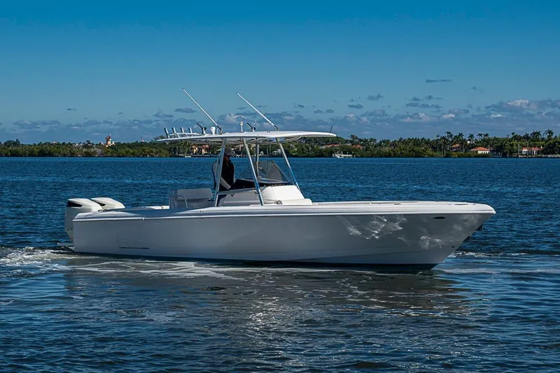 Slide: The Image of 2005 Intrepid 300 Center Console boat cruising on a sunny day. - 2