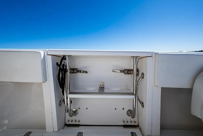 Slide: The Image of 2005 Intrepid 300 Center Console boat storage compartment under clear blue sky. - 21