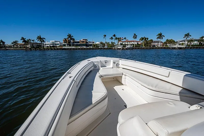 Slide: The Image of 2005 Intrepid 300 Center Console boat on calm water with palm trees in the background. - 24