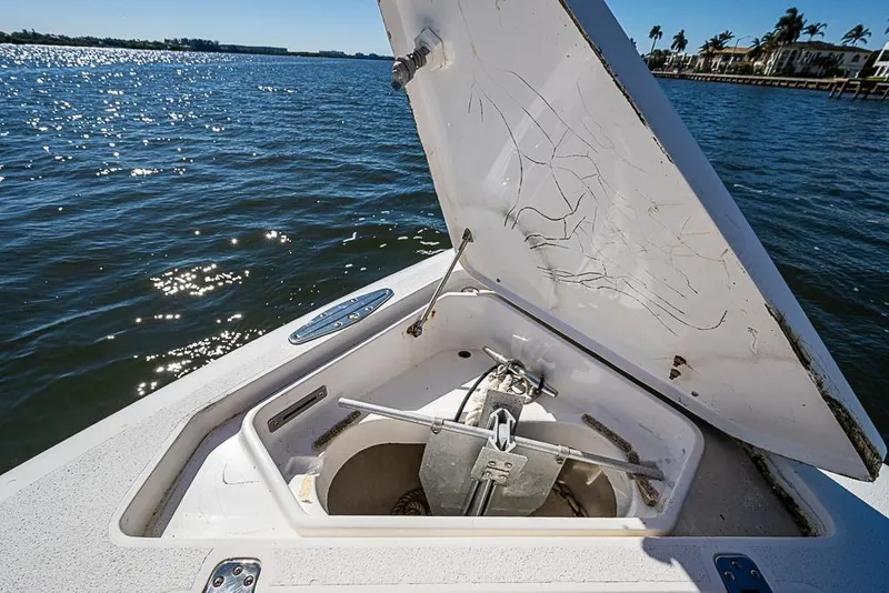 Slide: The Image of Open anchor compartment on 2005 Intrepid 300 Center Console boat, with scenic water view. - 26