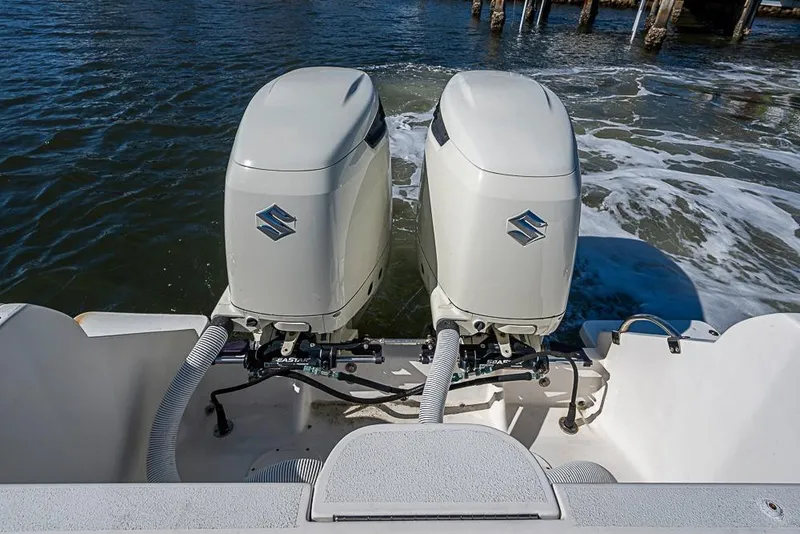 Slide: The Image of Twin outboard motors on a 2005 Intrepid 300 Center Console boat. - 30