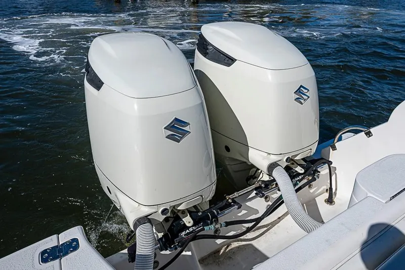 Slide: The Image of Twin Suzuki outboard engines on a 2005 Intrepid 300 Center Console boat. - 32