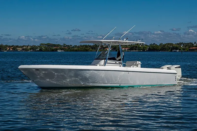 Slide: The Image of 2005 Intrepid 300 Center Console boat cruising on a sunny day. - 6