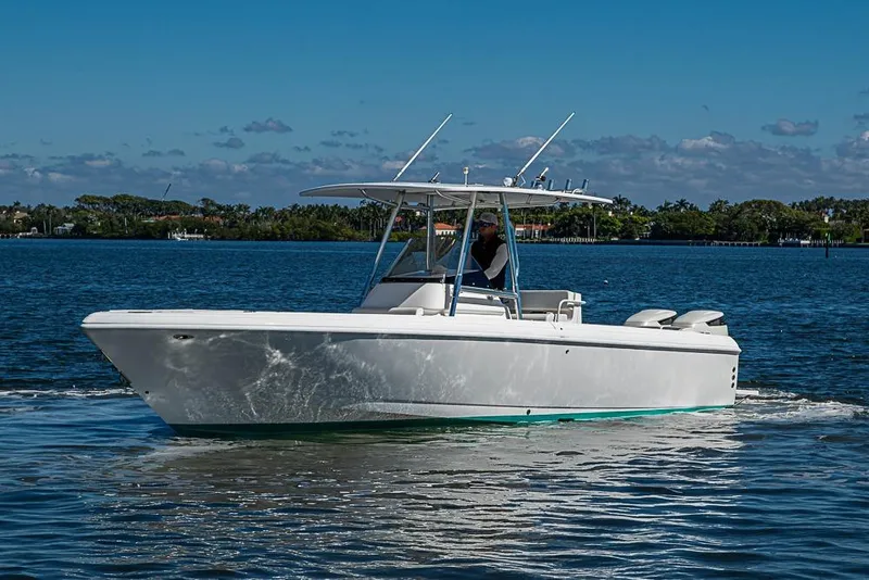 Slide: The Image of 2005 Intrepid 300 Center Console boat cruising on a sunny day. - 7