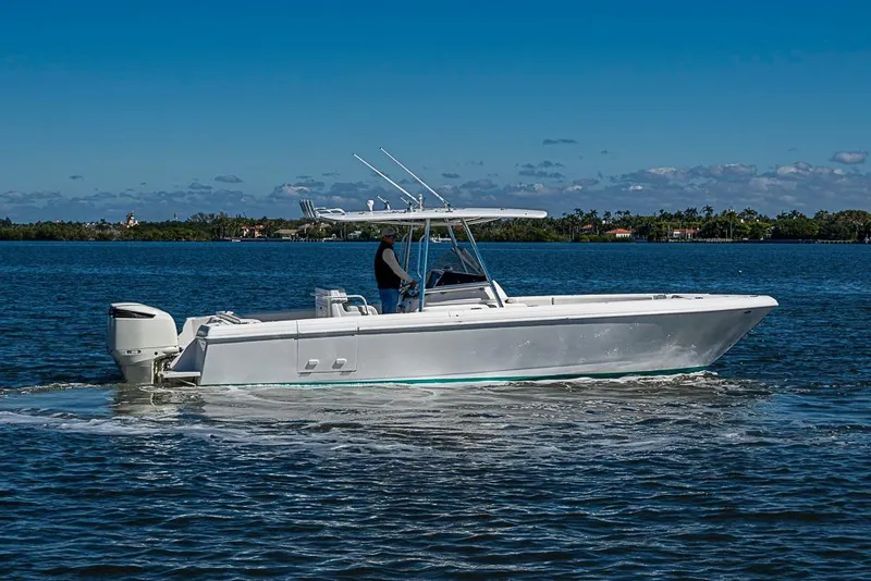 Slide: The Image of 2005 Intrepid 300 Center Console boat cruising on a sunny day. - 8