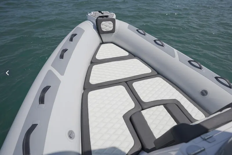 Slide: The Image of 2026 Highfield Sport 660 boat deck with cushioned seating on water. - 5