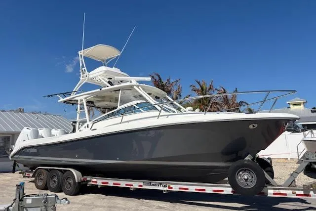 Slide: The Image of 2008 Everglades 350LX boat on trailer under clear blue sky. - 0