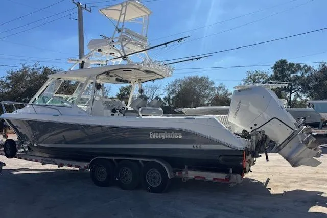 Slide: The Image of 2008 Everglades 350LX boat on trailer, featuring dual outboard engines. - 1