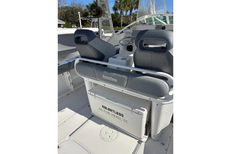Slide: The Image of 2008 Everglades 350LX boat interior with seating and storage, labeled "Relentless" from Hilton Head, SC. - 15