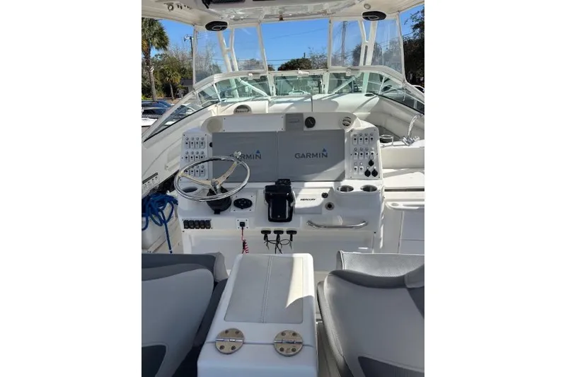 Slide: The Image of 2008 Everglades 350LX boat cockpit with Garmin navigation system and steering wheel. - 16