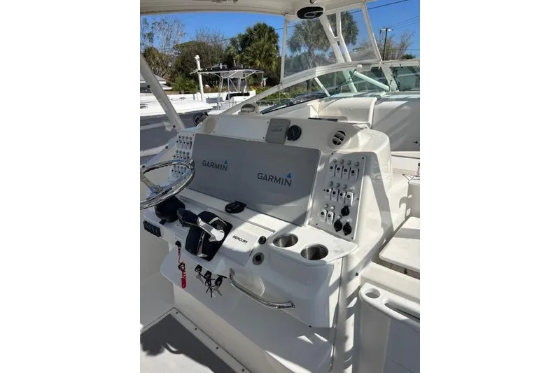 Slide: The Image of 2008 Everglades 350LX boat dashboard with Garmin navigation system and controls. - 17