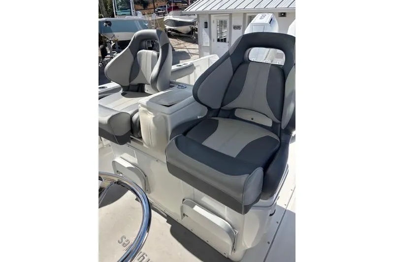 Slide: The Image of 2008 Everglades 350LX boat seats, gray and black, in a sunny marina setting. - 19