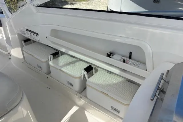 Slide: The Image of Interior view of 2008 Everglades 350LX boat with storage compartments and safety equipment. - 20