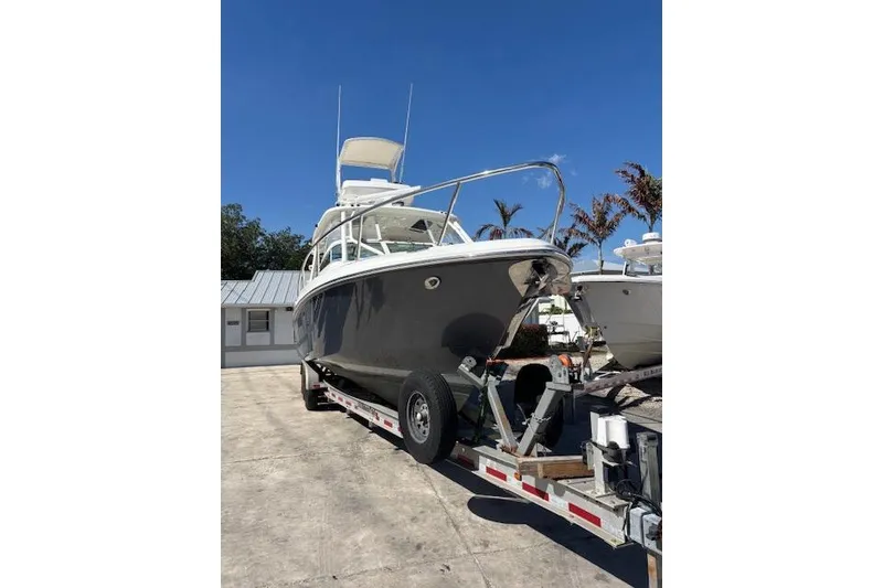 Slide: The Image of 2008 Everglades 350LX boat on trailer under clear blue sky. - 3
