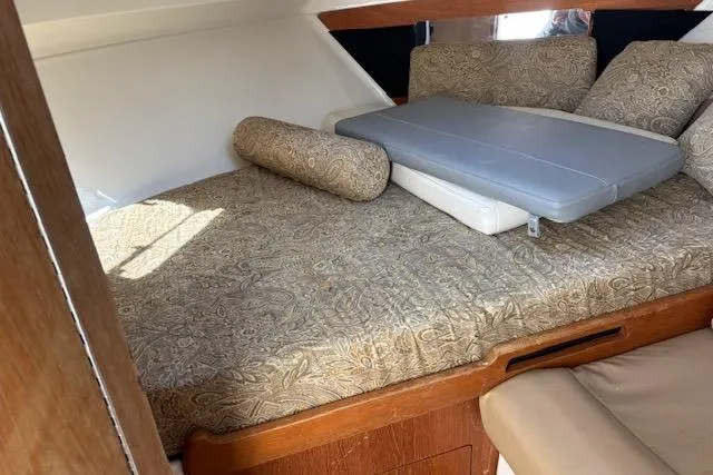 Slide: The Image of 2008 Everglades 350LX cabin interior with patterned bedding and wooden accents. - 30