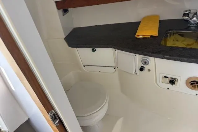 Slide: The Image of 2008 Everglades 350LX boat bathroom with toilet, sink, and countertop. - 31