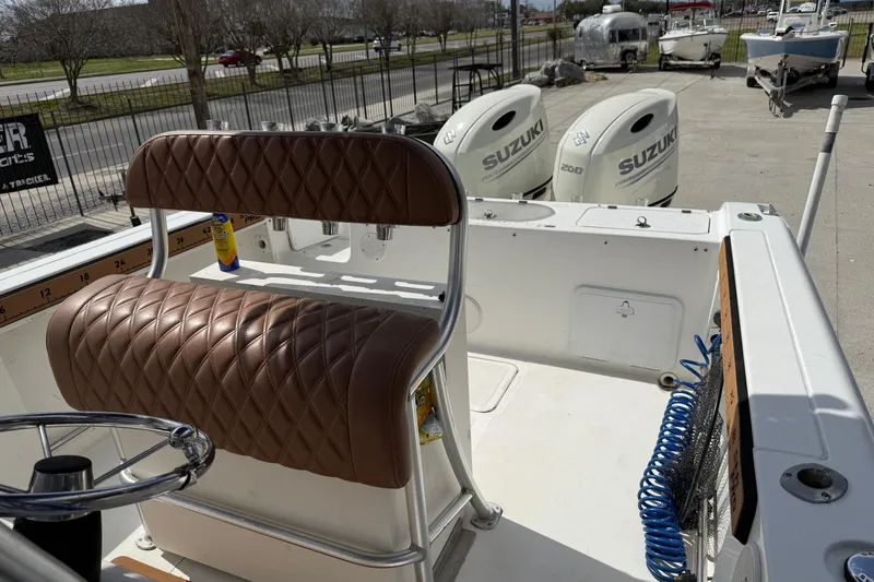 Slide: The Image of 2007 Sea Pro 270 Center Console boat with Suzuki engines and brown quilted seating. - 10
