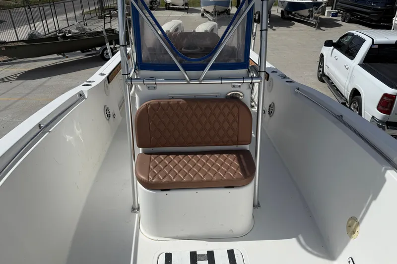 Slide: The Image of 2007 Sea Pro 270 Center Console boat with brown cushioned seating and blue canopy. - 9