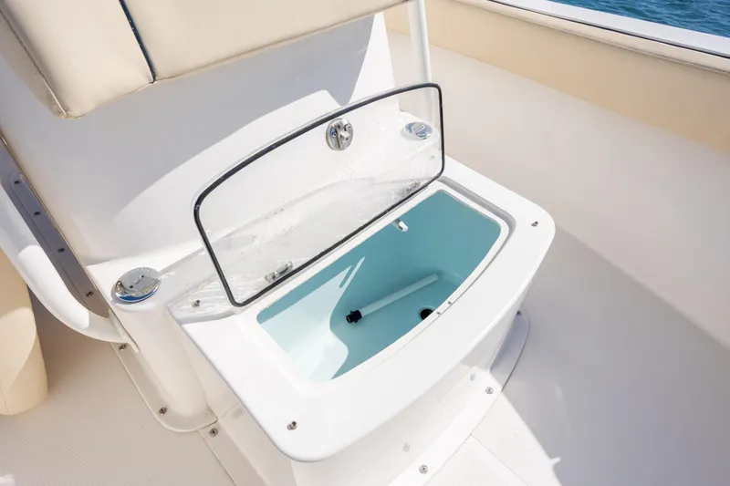 Slide: The Image of Open storage compartment on 2022 Century Coronado boat, featuring sleek design and ocean backdrop. - 19