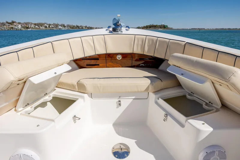 Slide: The Image of 2022 Century Coronado boat interior with beige seating and storage compartments. - 20