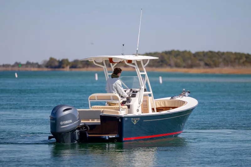 Slide: The Image of 2022 Century Coronado boat cruising on a calm lake with Yamaha engine. - 3
