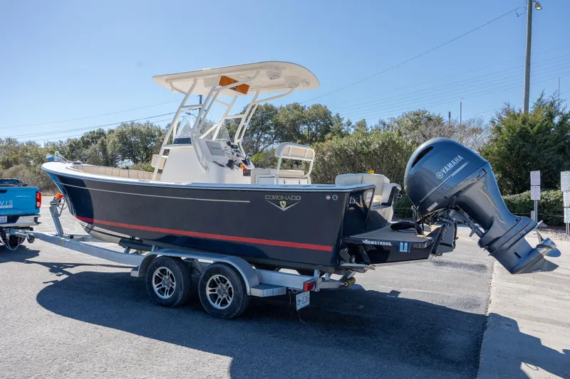 Slide: The Image of 2022 Century Coronado boat on trailer with Yamaha outboard motor, parked outdoors. - 30