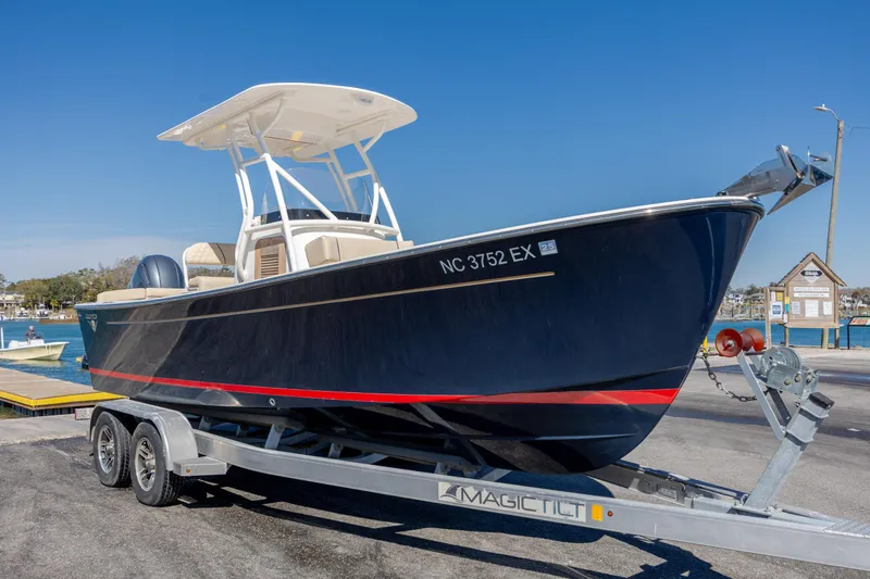 Slide: The Image of 2022 Century Coronado boat on trailer at marina under clear blue sky. - 32