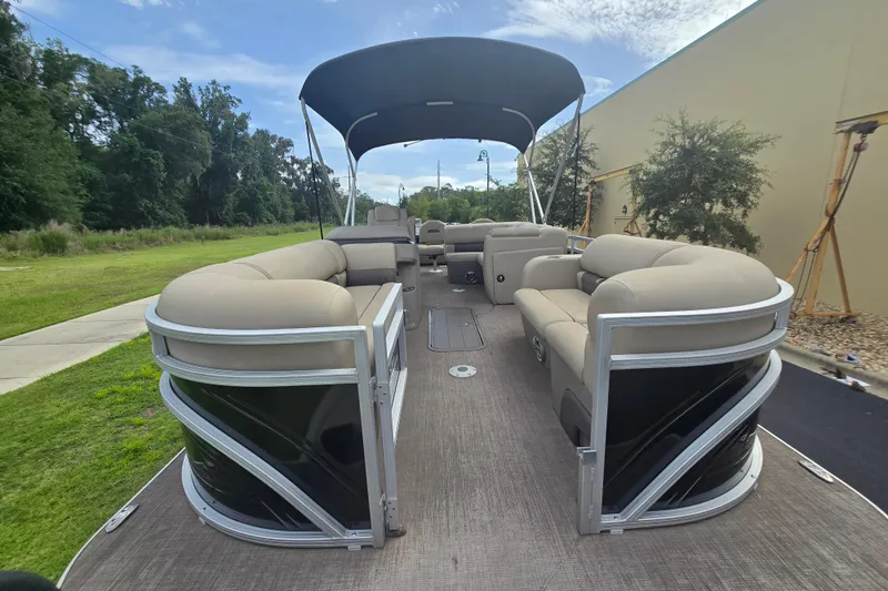 Slide: The Image of 2026 Sun Tracker Sportfish 24 XP3 pontoon boat with spacious seating and canopy. - 90