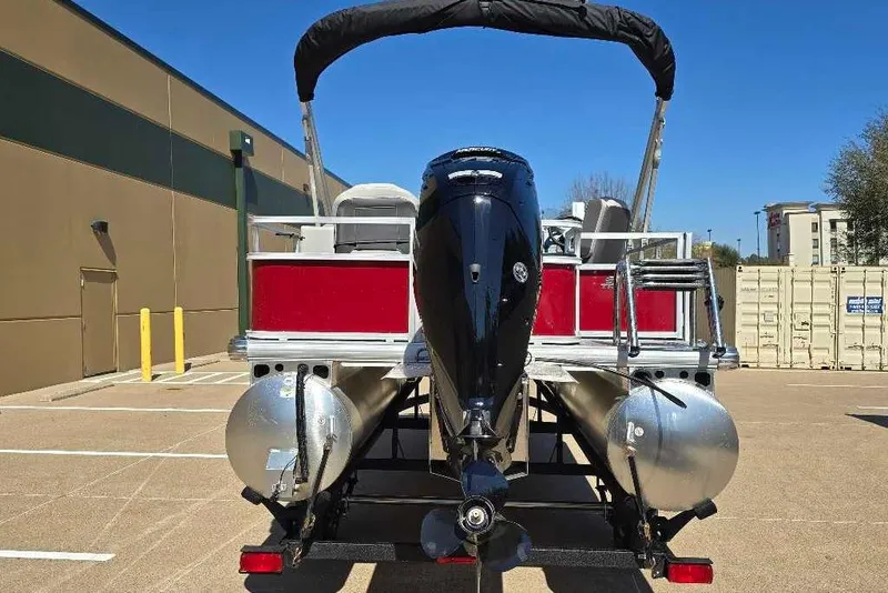 Slide: The Image of 2026 Sun Tracker Bass Buggy 18 DLX pontoon boat, rear view with outboard motor. - 3