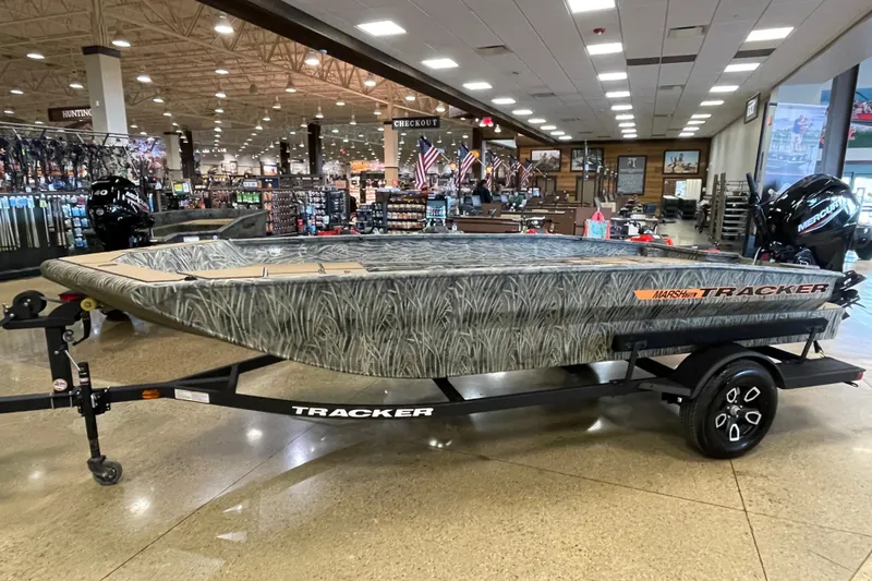 The Image of 2026 Tracker Grizzly 1756 T Marsh boat displayed in a showroom setting. - 0