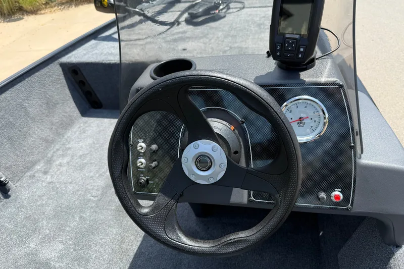 Slide: The Image of Steering console of 2026 Tracker Bass Tracker Classic XL boat with RPM gauge and controls. - 7