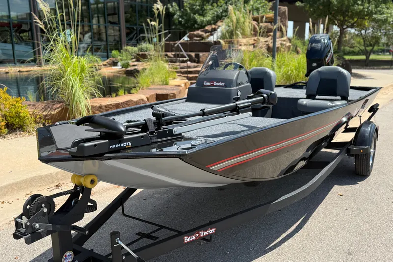 Slide: The Image of 2026 Tracker Bass Tracker Classic XL boat on trailer, parked outdoors. - 2