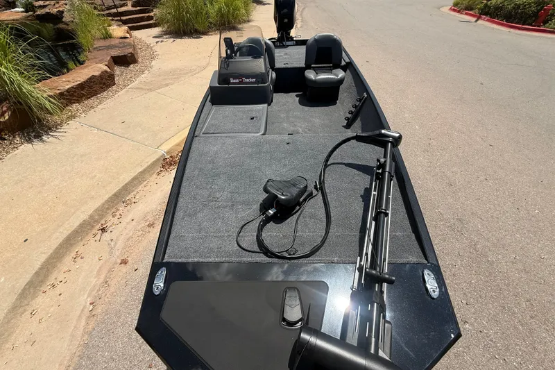 Slide: The Image of 2026 Tracker Bass Tracker Classic XL boat with seating and fishing equipment on a sunny day. - 3