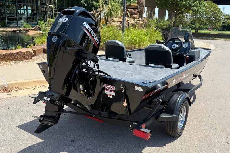 Slide: The Image of 2026 Tracker Bass Tracker Classic XL boat with Mercury engine, parked outdoors. - 6