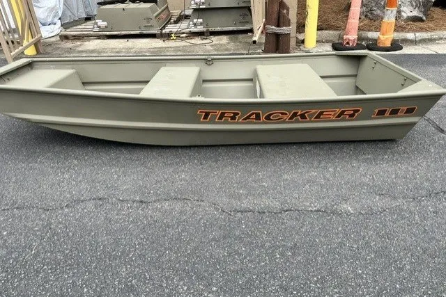 The Image of 2026 Tracker Grizzly 10 Jon boat on pavement, showcasing durable design and compact size. - 0