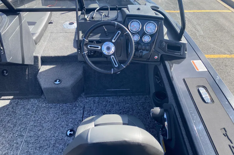 Slide: The Image of 2026 Tracker Targa V-19 Combo boat interior with steering wheel and dashboard controls. - 75