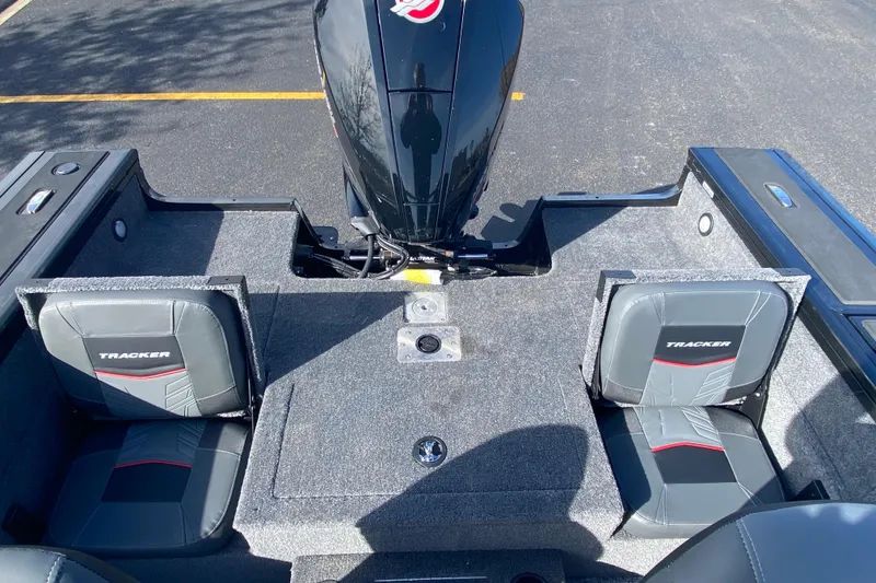 Slide: The Image of 2026 Tracker Targa V-19 Combo boat interior with dual seats and motor. - 79