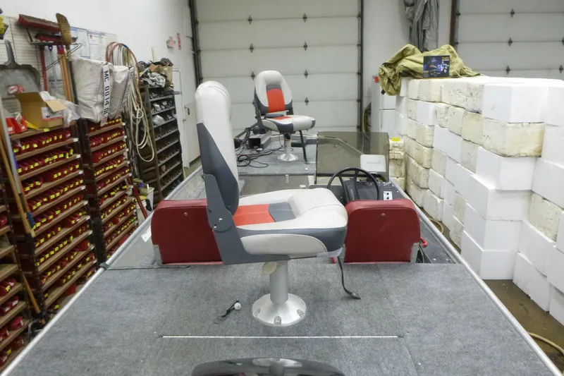 Slide: The Image of 1988 Sea Nymph TX170 boat interior with seats, steering wheel, and storage shelves. - 11