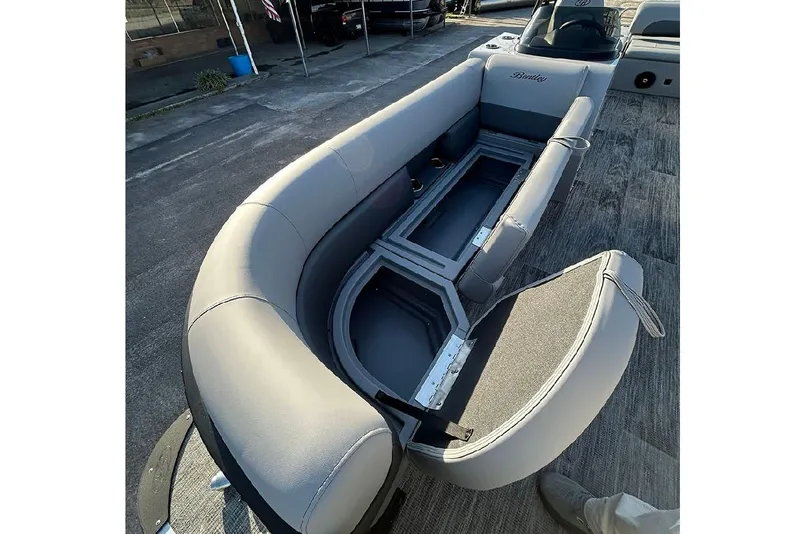 Slide: The Image of 2026 Bentley Pontoons Legacy 243 Swingback with open storage compartment and luxurious seating. - 20