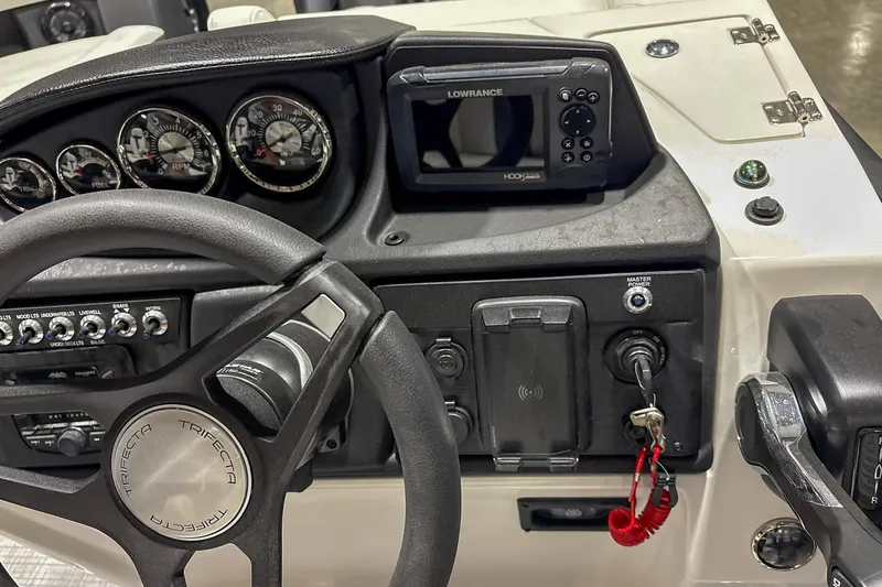 Slide: The Image of Dashboard of 2025 Trifecta 22RF CS boat with steering wheel and control panel. - 10